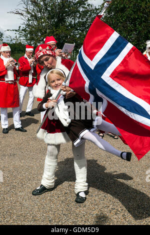 Copenhagen, Denmark – July 18, 2016:  Santa Claus’ participating in the World Santa Claus Congress 2016 visits the harbor promenade, Langelinie, where the sculpture, The Little Mermaid is placed. At the photo a girl from Norway have fun with one of the Santa elves. The congress has taken place since 1957. The venue and organizer is Bakken, the world’s oldest amusement park and located north of Copenhagen. Credit:  OJPHOTOS/Alamy Live News Stock Photo