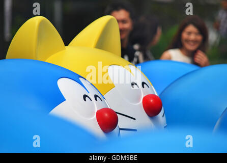 Tokyo, Japan. 16th July, 2016. People past near figures of anime manga character Doraemon displayed at Tokyo's Roppongi Hills Shopping Center in Tokyo Japan. July 14, 2016. Photo by: Ramiro Agustin Vargas Tabares © Ramiro Agustin Vargas Tabares/ZUMA Wire/Alamy Live News Stock Photo
