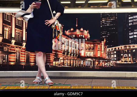Tokyo, Japan. 16th July, 2016. A lady stands at Tokyo Station as she awaits her train during a summer day in Tokyo Japan. July 10, 2016. Photo by: Ramiro Agustin Vargas Tabares © Ramiro Agustin Vargas Tabares/ZUMA Wire/Alamy Live News Stock Photo