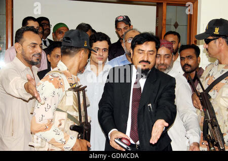 Sindh High Court Chief Justice Sajjad Ali Shah along with his son Advocate Awais Ali Shah, who returned after 29 days recovered by security forces from custody of terrorists during an operation near Tank, show to media persons during press conference at his residency in Karachi on Tuesday, July 19, 2016. Stock Photo