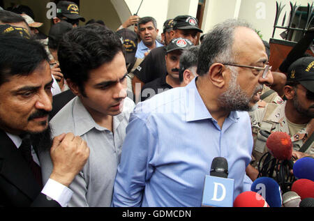 Sindh High Court Chief Justice Sajjad Ali Shah along with his son Advocate Awais Ali Shah, who returned after 29 days recovered by security forces from custody of terrorists during an operation near Tank, addresses to media persons during press conference at his residency in Karachi on Tuesday, July 19, 2016. Stock Photo