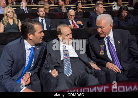 Former Senator Bob Dole, center, sits with Senator Orrin Hatch, right, and Don Trump, Jr., son of GOP Presidential nominee Donald Trump during the first day of the Republican National Convention at the Quicken Loans Center July 18, 2016 in Cleveland, Ohio. Stock Photo