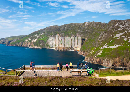 Slieve League, County Donegal, Ireland weather. 19th July 2016 . People enjoy the view from the highest sea cliffs in Europe, on the hottest day of the year so far. The 'Wild Atlantic Way' is attracting many foreign tourists to Ireland this year as people reject the possible dangers of Mediterranean destinations. Credit:  Richard Wayman/Alamy Live News Stock Photo