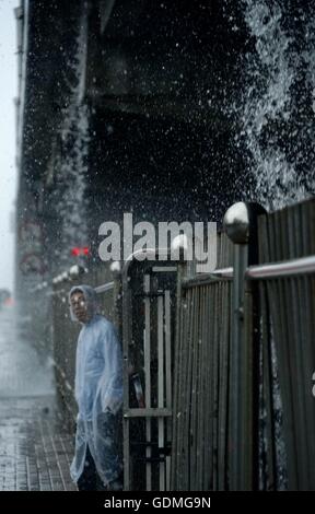 Beijing, China. 20th July, 2016. Water flow down from an elevated road in Beijing, capital of China, July 20, 2016. An orange alert, the second highest of China's four-tier warning system, was issued on Wednesday as heavy rain hit Beijing, disrupting the traffic and forcing flights to be canceled. Credit:  Li Xin/Xinhua/Alamy Live News Stock Photo