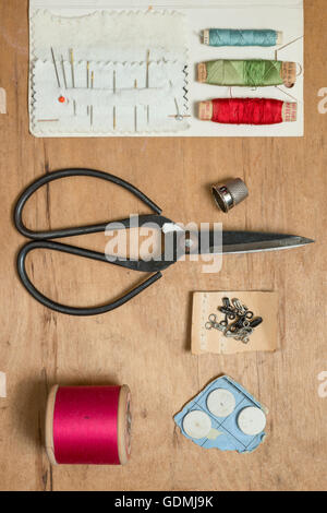 Basic sewing kit on a wooden surface Stock Photo
