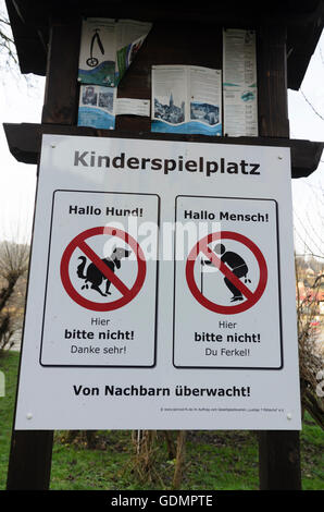 Wehlen: Children's playground with a joking sign regarding dog droppings, Germany, Sachsen, Saxony, Stock Photo