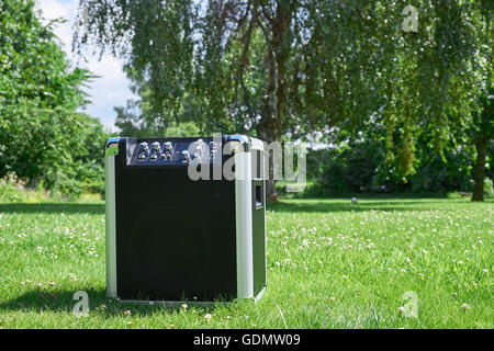 Cordless transportable festival music player on a grass lawn in a park Stock Photo