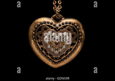 Heart-shaped necklace on black background Stock Photo