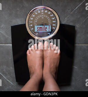 the bathroom scales that speaks to you and tells you the truth by writing it on the screen: you smile! Stock Photo