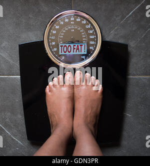 the bathroom scales that speaks to you and tells you the truth by writing it on the screen: too fat! Stock Photo