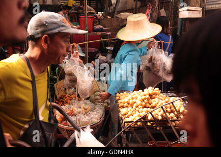 People at the Talat Warorot in the city of chiang mai in the north of Thailand in Southeastasia. Stock Photo