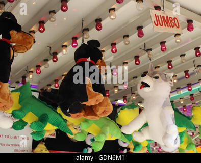 Carnival prizes hanging under lights Stock Photo