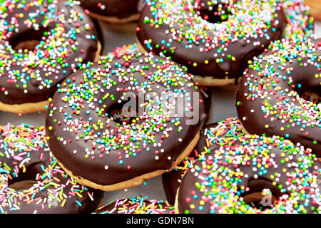Chocolate donuts with chocolate shavings color on a traditional craftsman market.Horizontal image. Stock Photo