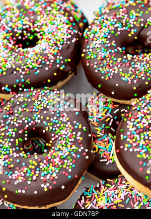 Chocolate donuts with chocolate shavings color on a traditional craftsman market.Vertical image. Stock Photo
