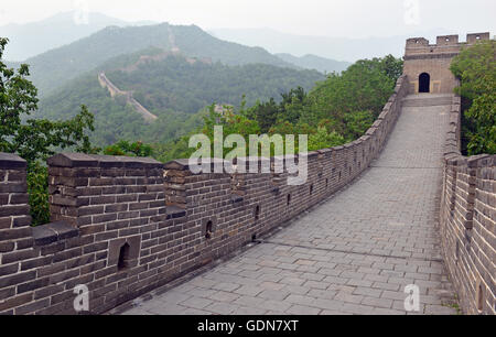 Great Wall of China atop the mountains in the forest, showing air pollution and smog, China Stock Photo