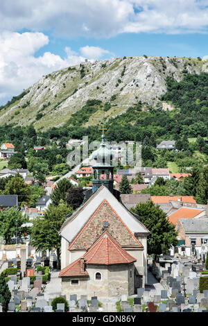 Church with cemetery and Braunsberg hill, Hainburg an der Donau, Austria. Religious architecture. Cultural heritage. Stock Photo