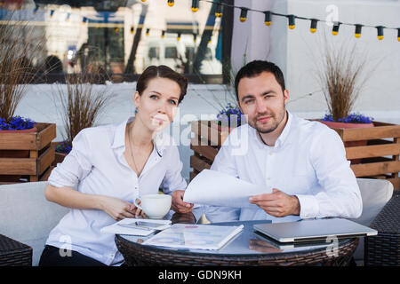 Young business people shake their hands in summer cafe Stock Photo