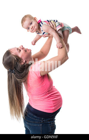 pregnant woman holding baby in the air over white background Stock Photo