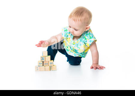 Happy kid playing toy blocks  isolated on white background Stock Photo