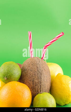 Raw fruit mix placed against green background Stock Photo