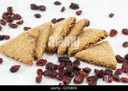 Integral triangle cookies with red raisins on white table Stock Photo