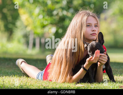 Young pretty girl with french bulldog puppy Stock Photo