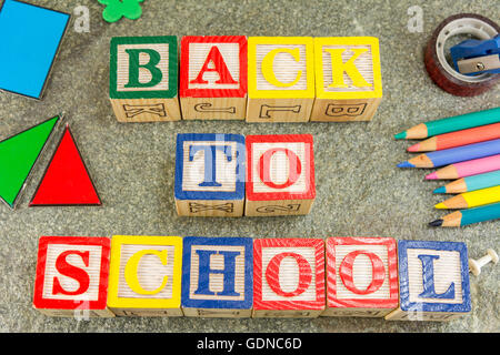 Back to school written with wooden letters and learning tools Stock Photo