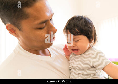 Father comforting crying baby Stock Photo