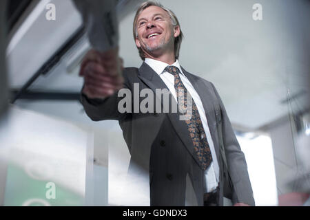 Low angle view of businessmen shaking hands in office Stock Photo