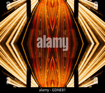 Abstract mirror image of highway traffic and light trails at night Stock Photo