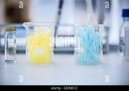 Glass beakers filled with test tubes, still life, close-up Stock Photo