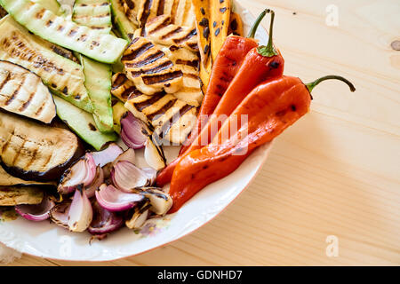 Mix of roasted vegetables and halloumi on a wooden rustic table, space for text Stock Photo