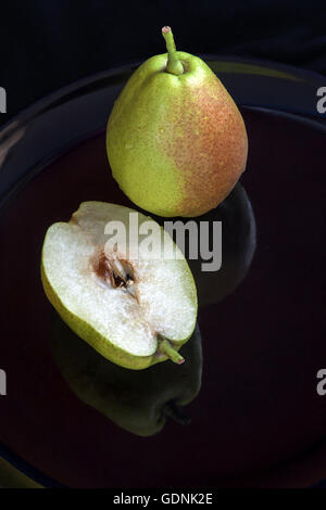 Fragrant pears . sweet fragrant flavor and aroma on black dish Stock Photo