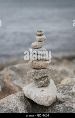 rock cairn built on the Rhode Island shoreline Stock Photo