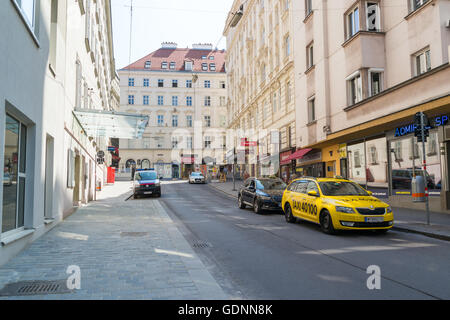 Taxi stand and police car parked in Laurenzerberg street in downtown Vienna, Austria Stock Photo