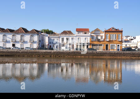 Portuguese waterfront architecture reflected on water on warm and sunny afternoon with blue skies in Tavira, near Faro in Algarve Region of Portugal. Stock Photo