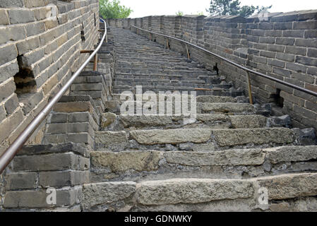 Great Wall of China atop the mountains in the forest, showing air pollution and smog, China Stock Photo