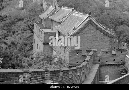 Great Wall of China atop the mountains in the forest, showing air pollution and smog, China Stock Photo