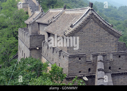 Great Wall of China atop the mountains in the forest, showing air pollution and smog, China Stock Photo