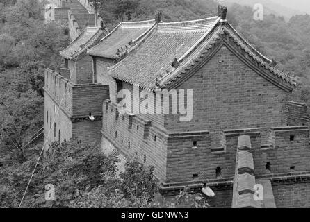 Great Wall of China atop the mountains in the forest, showing air pollution and smog, China Stock Photo