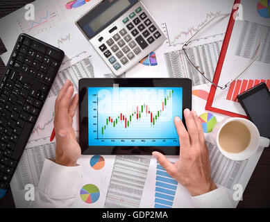 hands using digital tablet with chart on screen Stock Photo