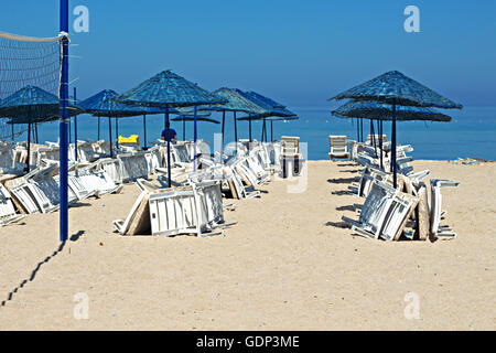 Empty sun loungers on a Turkish beach at midday in the middle of July Stock Photo
