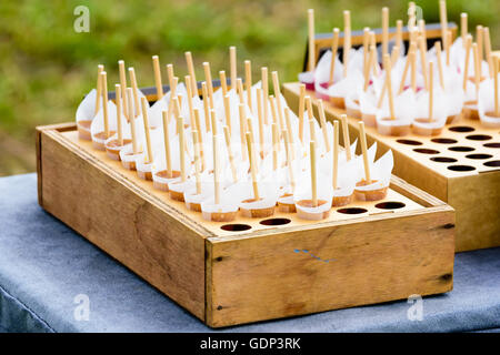 Collection of butterscotch cones candy in a makeshift display made of a wooden box and some corrugated board. Stock Photo