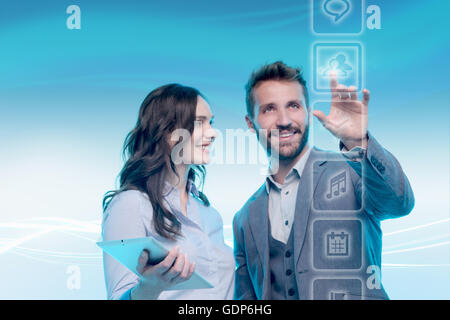 Man and woman using graphical screen, man touching icon Stock Photo