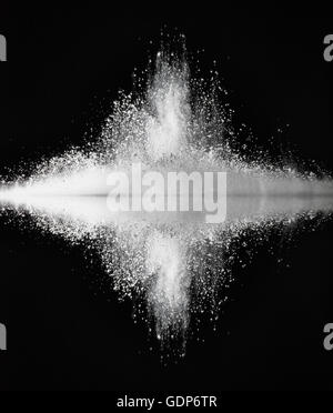 White dust exploding against mirror surface impact Stock Photo