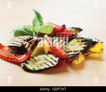 Food, cooked vegetables, grilled courgettes, red peppers, yellow peppers, basil leaf Stock Photo