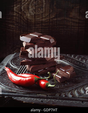 Food, chilli chocolate, raw red chilli peppers, vintage wooden surface Stock Photo