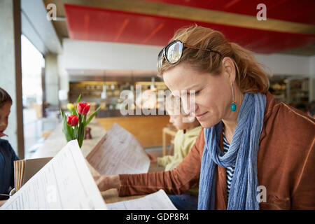 Mother and son at cafe looking at menu Stock Photo