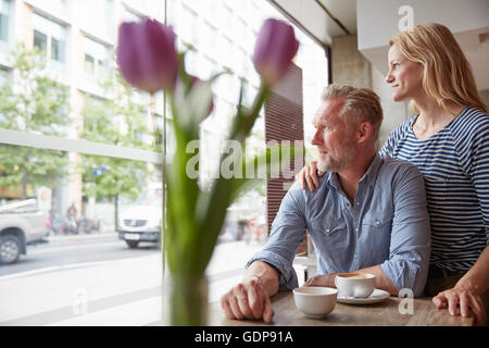 Mature couple in coffee shop looking out of window Stock Photo