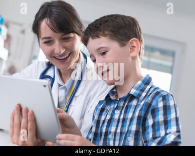 Doctor and boy using digital tablet Stock Photo